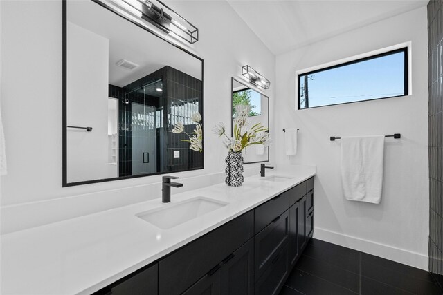 bathroom featuring walk in shower, tile patterned flooring, and vanity