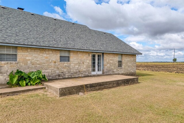 back of house featuring a yard, french doors, and a patio area