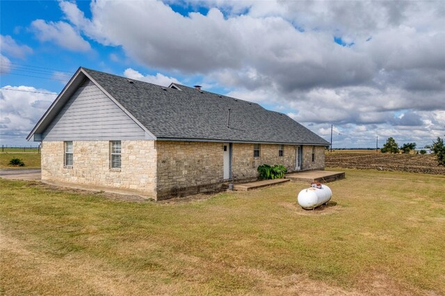 rear view of house with a yard and a patio area