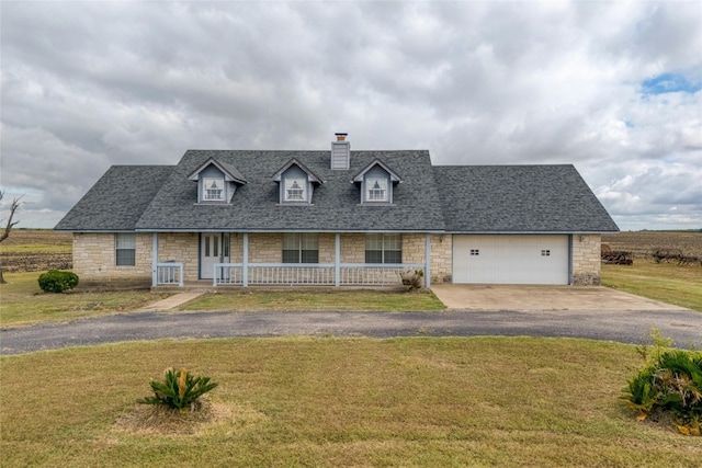 view of front facade featuring a front lawn, a porch, and a garage