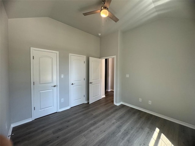 unfurnished bedroom featuring dark hardwood / wood-style flooring, ceiling fan, and lofted ceiling