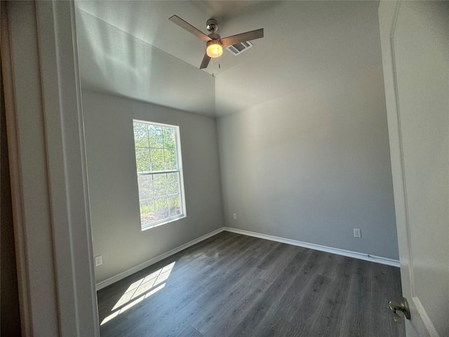 empty room featuring dark hardwood / wood-style flooring and ceiling fan
