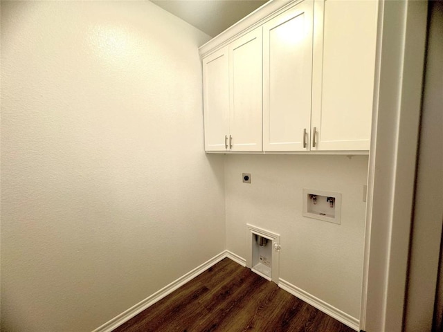 laundry area featuring hookup for an electric dryer, hookup for a washing machine, dark hardwood / wood-style flooring, and cabinets