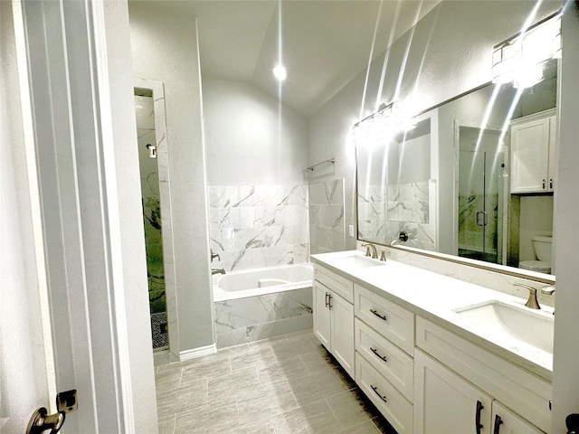 full bathroom featuring tile patterned flooring, vaulted ceiling, toilet, vanity, and independent shower and bath