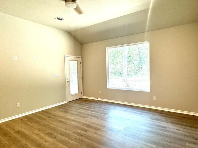 empty room featuring ceiling fan, lofted ceiling, and hardwood / wood-style flooring
