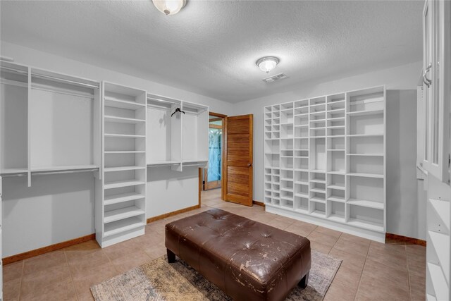 spacious closet with tile patterned floors