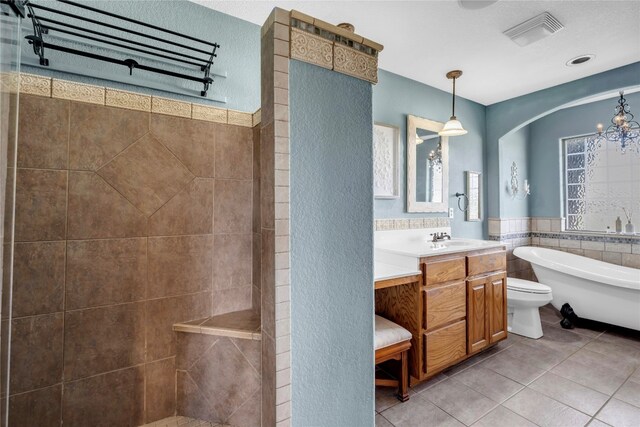 full bathroom featuring vanity, toilet, plus walk in shower, tile walls, and tile patterned flooring