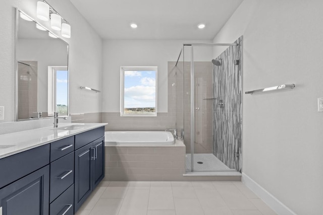 bathroom with tile patterned flooring, plus walk in shower, and vanity