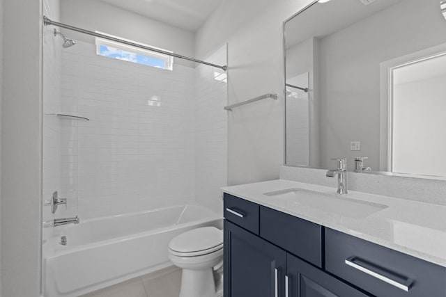 full bathroom featuring vanity, tile patterned flooring, toilet, and tiled shower / bath