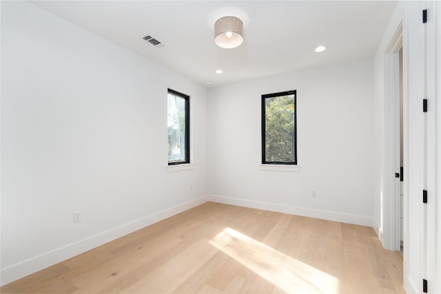 unfurnished room with light hardwood / wood-style floors