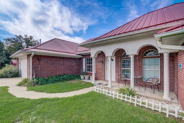 exterior space featuring a garage and a front lawn