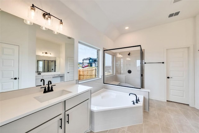 bathroom with tile patterned floors, vanity, lofted ceiling, and independent shower and bath