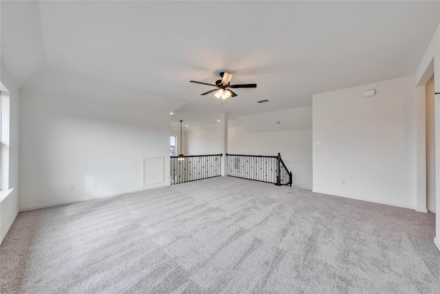 carpeted spare room featuring ceiling fan