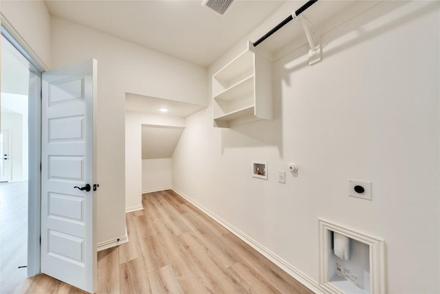 clothes washing area with hookup for an electric dryer, hookup for a washing machine, light wood-type flooring, and hookup for a gas dryer