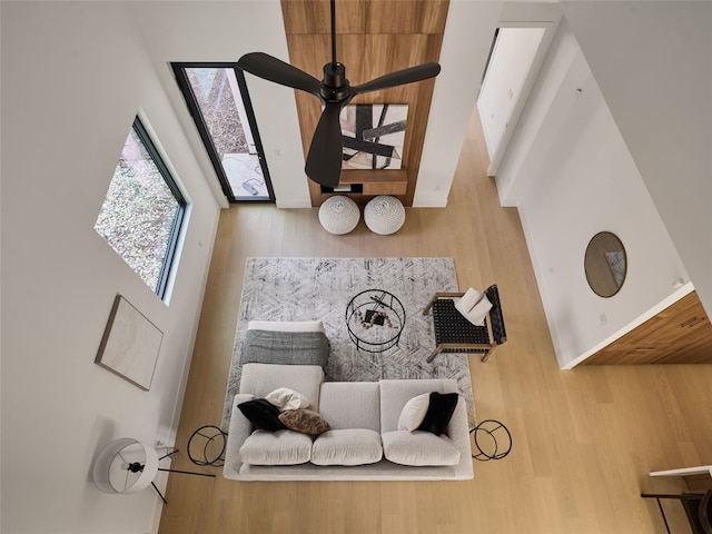 living area with ceiling fan and wood finished floors