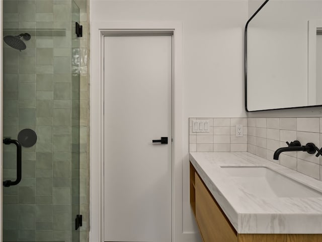 bathroom with a stall shower and vanity