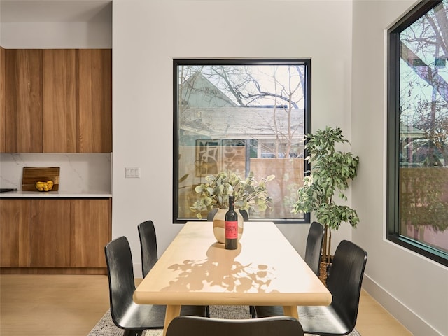 dining area with plenty of natural light and baseboards