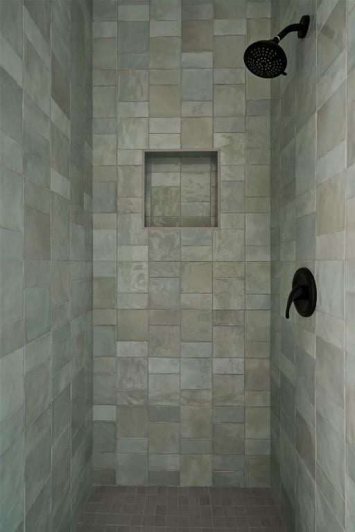 bathroom with tiled shower