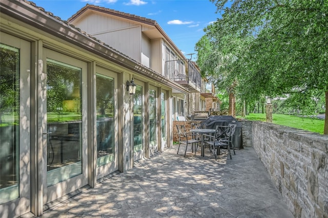 view of patio / terrace with a balcony and a grill