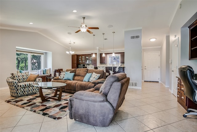 living room with ceiling fan with notable chandelier, light tile patterned floors, and plenty of natural light