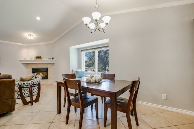 tiled dining area featuring vaulted ceiling, ornamental molding, and a chandelier