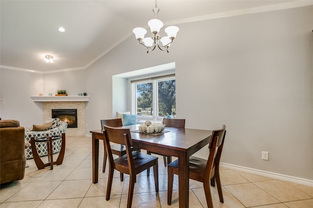 100 Bay Point Dr Unit 13, Horseshoe Bay, TX 78657 - dining area with lofted ceiling, a chandelier, a glass covered fireplace, light tile patterned floors, and baseboards