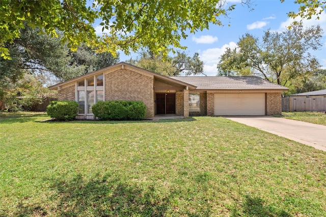 ranch-style home featuring a garage and a front lawn