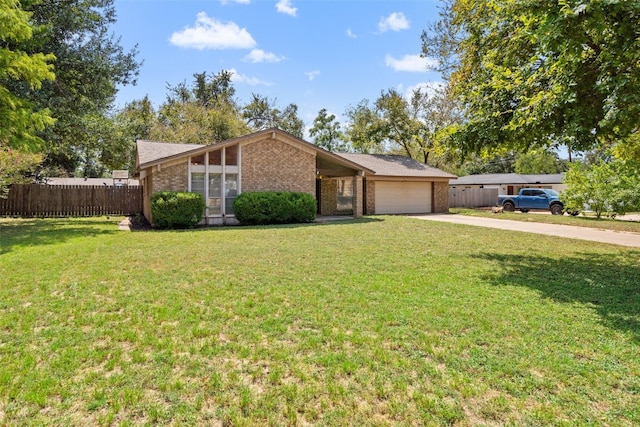 ranch-style house with a garage and a front lawn