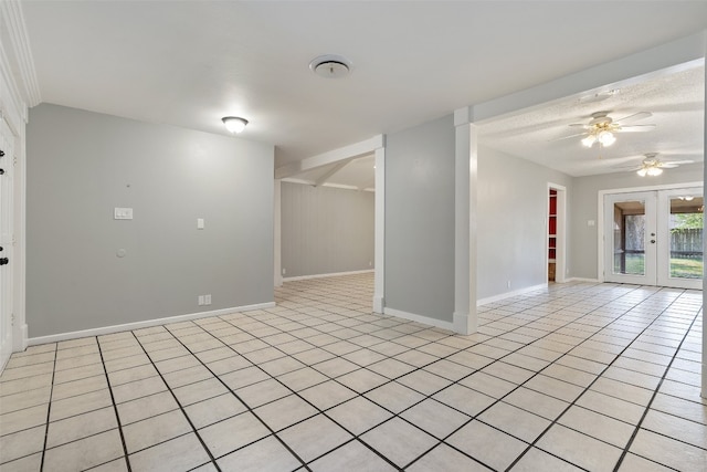 spare room featuring light tile patterned floors, ceiling fan, and french doors