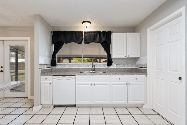 kitchen featuring a textured ceiling, light tile patterned flooring, sink, white cabinets, and white dishwasher