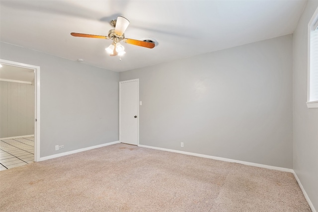 empty room featuring ceiling fan and light colored carpet