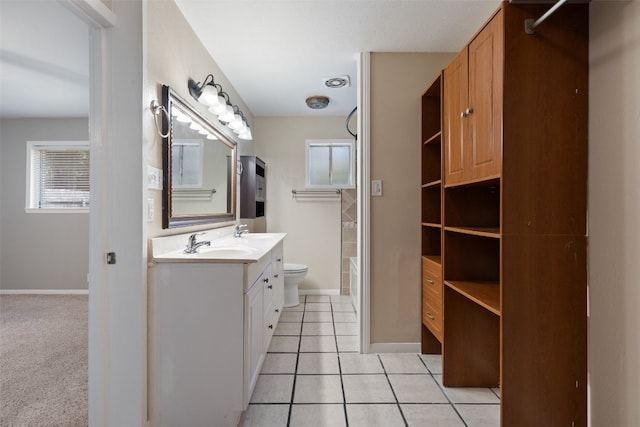 bathroom with vanity, tile patterned flooring, and toilet