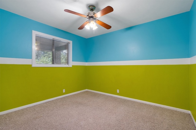 empty room featuring ceiling fan and carpet floors