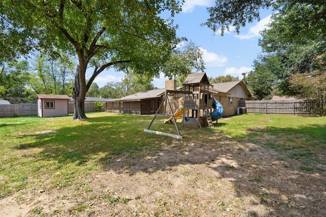 view of yard with a playground and a storage shed