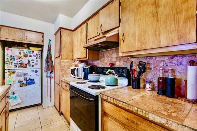 kitchen featuring white appliances, tile countertops, light tile patterned floors, and tasteful backsplash