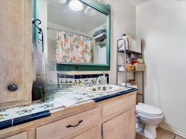 bathroom featuring vanity, tile patterned flooring, and toilet