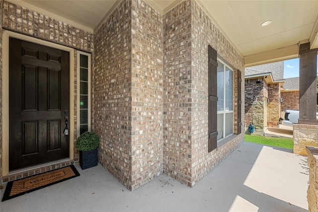 view of exterior entry with covered porch