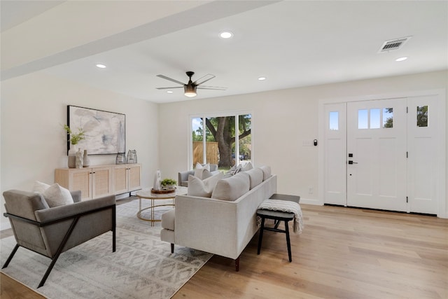 living room featuring ceiling fan and light hardwood / wood-style flooring