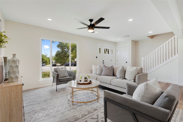 living room with ceiling fan and light wood-type flooring