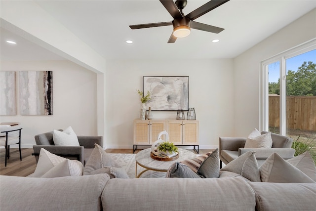 living room with ceiling fan and light wood-type flooring