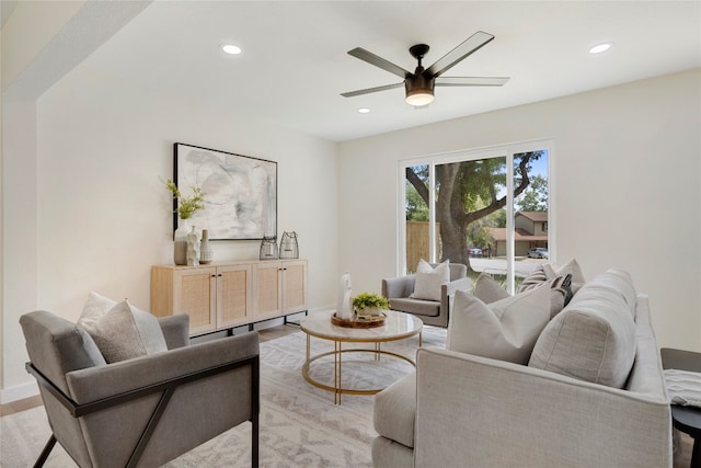 living room with light hardwood / wood-style flooring and ceiling fan