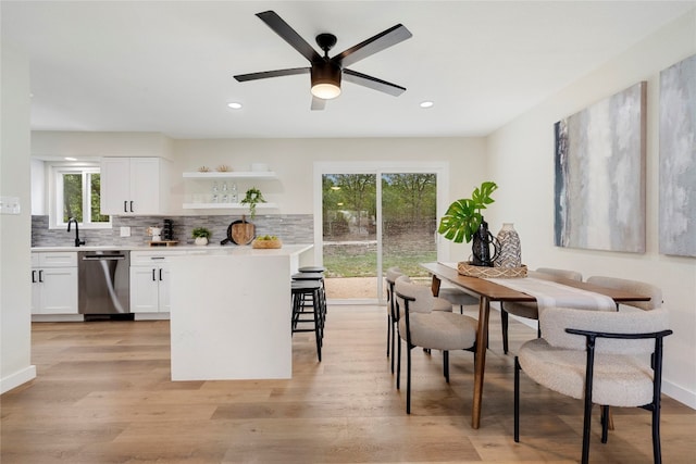 kitchen with ceiling fan, white cabinets, plenty of natural light, and stainless steel dishwasher