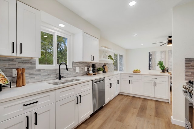 kitchen with white cabinets, sink, plenty of natural light, stainless steel appliances, and light wood-type flooring