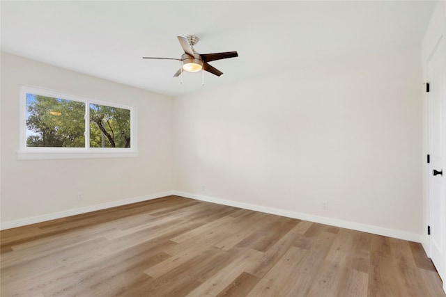 spare room with ceiling fan and light wood-type flooring