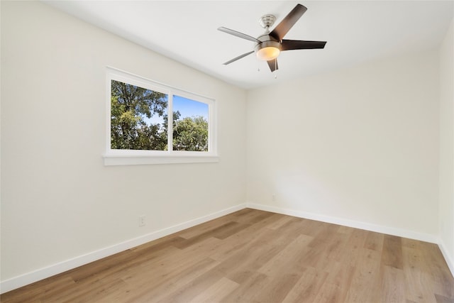 empty room with ceiling fan and light wood-type flooring