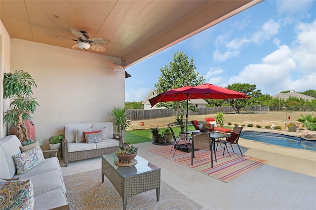 view of patio / terrace featuring outdoor lounge area, a fenced in pool, and ceiling fan