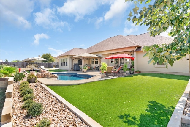 view of swimming pool with a patio area and a yard