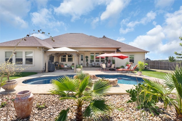 view of swimming pool featuring ceiling fan and a patio