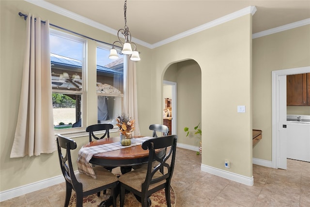 dining space featuring washer / dryer and ornamental molding