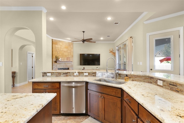 kitchen with dishwasher, light stone counters, sink, and tasteful backsplash